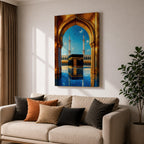 A vibrant framed canvas artwork depicting the Kaaba viewed through a golden arched doorway at Masjid Al Haram in Mecca. The scene shows the iconic black cube structure with gold detailing, two minarets in the background, and a reflective tiled floor under a bright blue sky with birds flying.