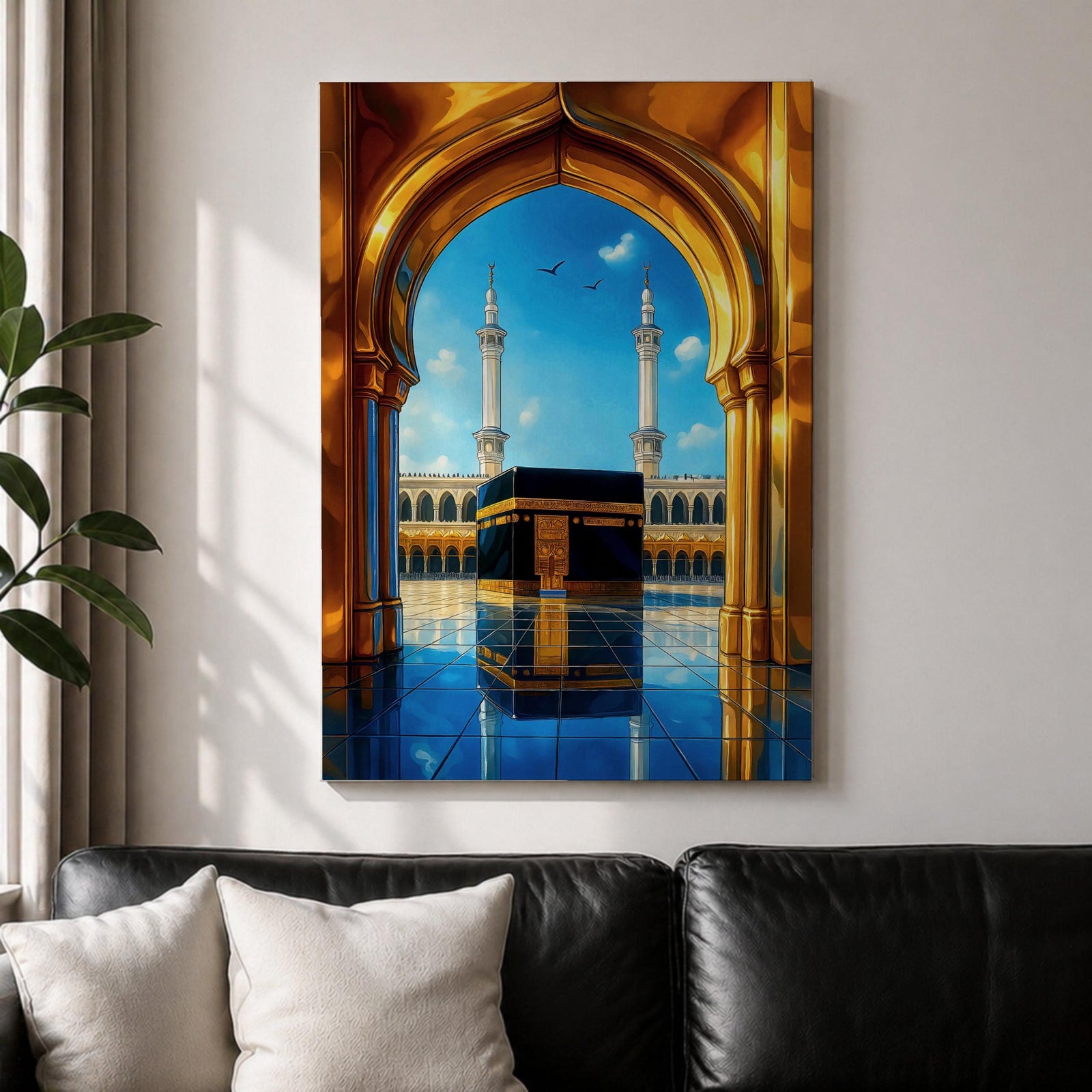 A vibrant framed canvas artwork depicting the Kaaba viewed through a golden arched doorway at Masjid Al Haram in Mecca. The scene shows the iconic black cube structure with gold detailing, two minarets in the background, and a reflective tiled floor under a bright blue sky with birds flying.