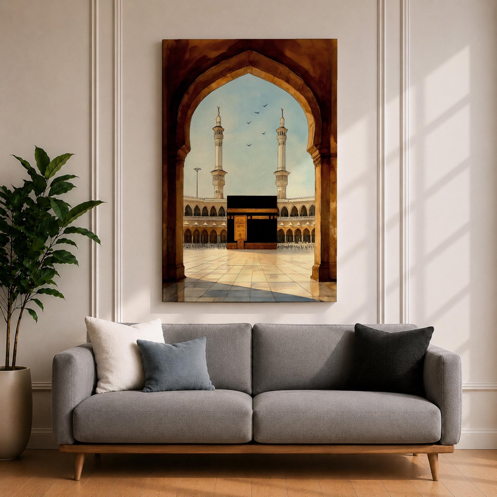 A watercolor style framed canvas depicting the Kaaba viewed through an arched gateway, showing the black cube structure with golden door and surrounding mosque minarets under a clear sky with flying birds, rendered in warm tones and detailed architectural elements.