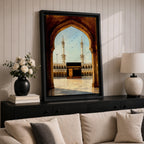 A watercolor style framed canvas depicting the Kaaba viewed through an arched gateway, showing the black cube structure with golden door and surrounding mosque minarets under a clear sky with flying birds, rendered in warm tones and detailed architectural elements.