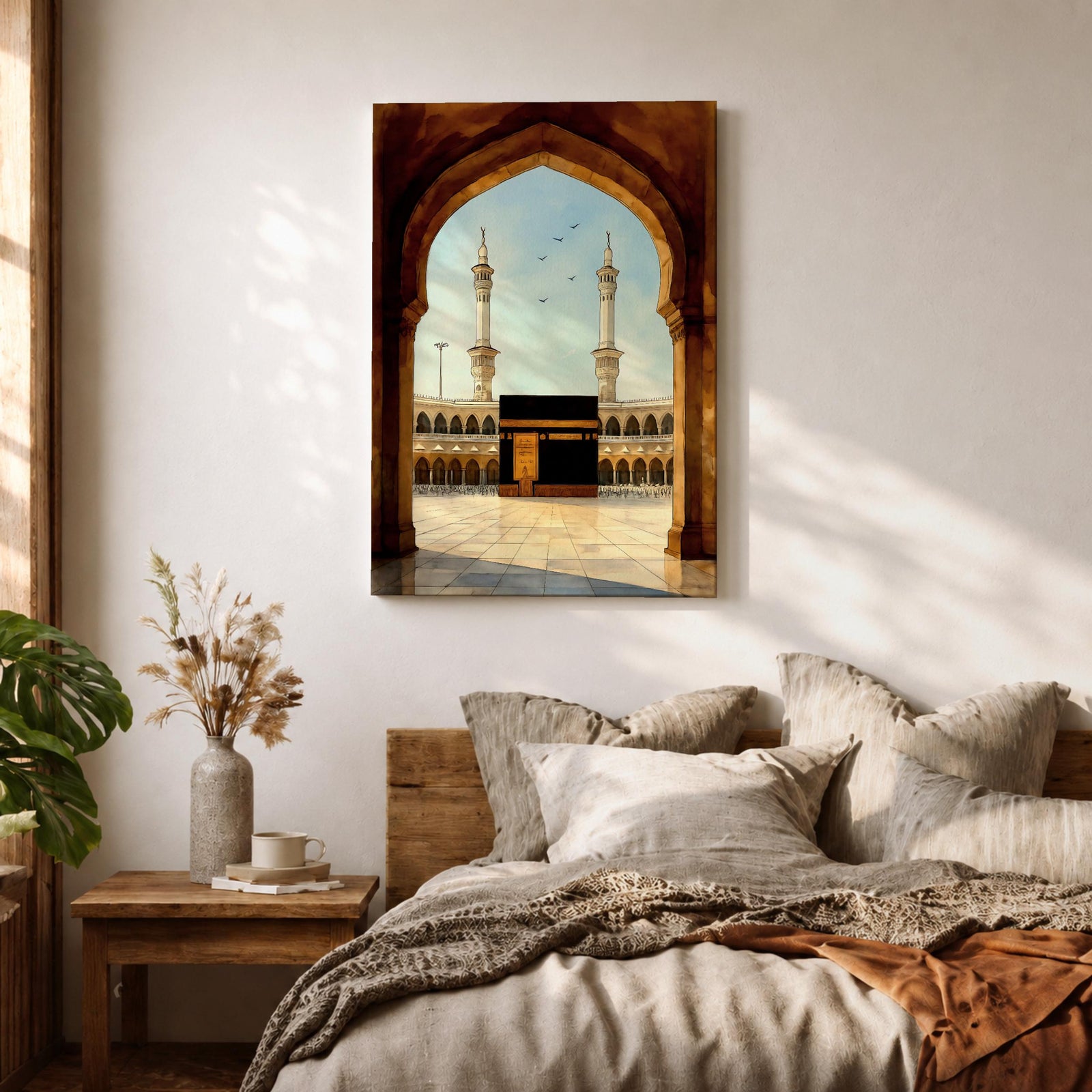 A watercolor style framed canvas depicting the Kaaba viewed through an arched gateway, showing the black cube structure with golden door and surrounding mosque minarets under a clear sky with flying birds, rendered in warm tones and detailed architectural elements.