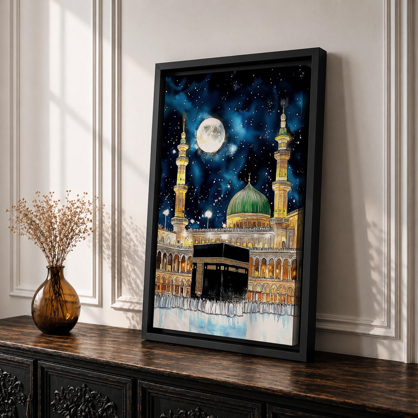 Painting of the Kaaba at Masjid Al Haram under a night sky filled with stars and a large full moon, surrounded by illuminated mosque arcades and tall minarets with pilgrims gathered around the sacred cube, while the green dome of Masjid Al Nabawi appears in the background within the composition.