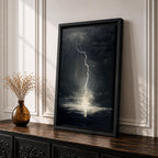 A framed canvas wall art depicting a dramatic lightning bolt striking over a stormy ocean seascape. The dark clouds and turbulent water create a powerful natural scene emphasizing the raw energy of lightning over the sea, captured in a realistic style.