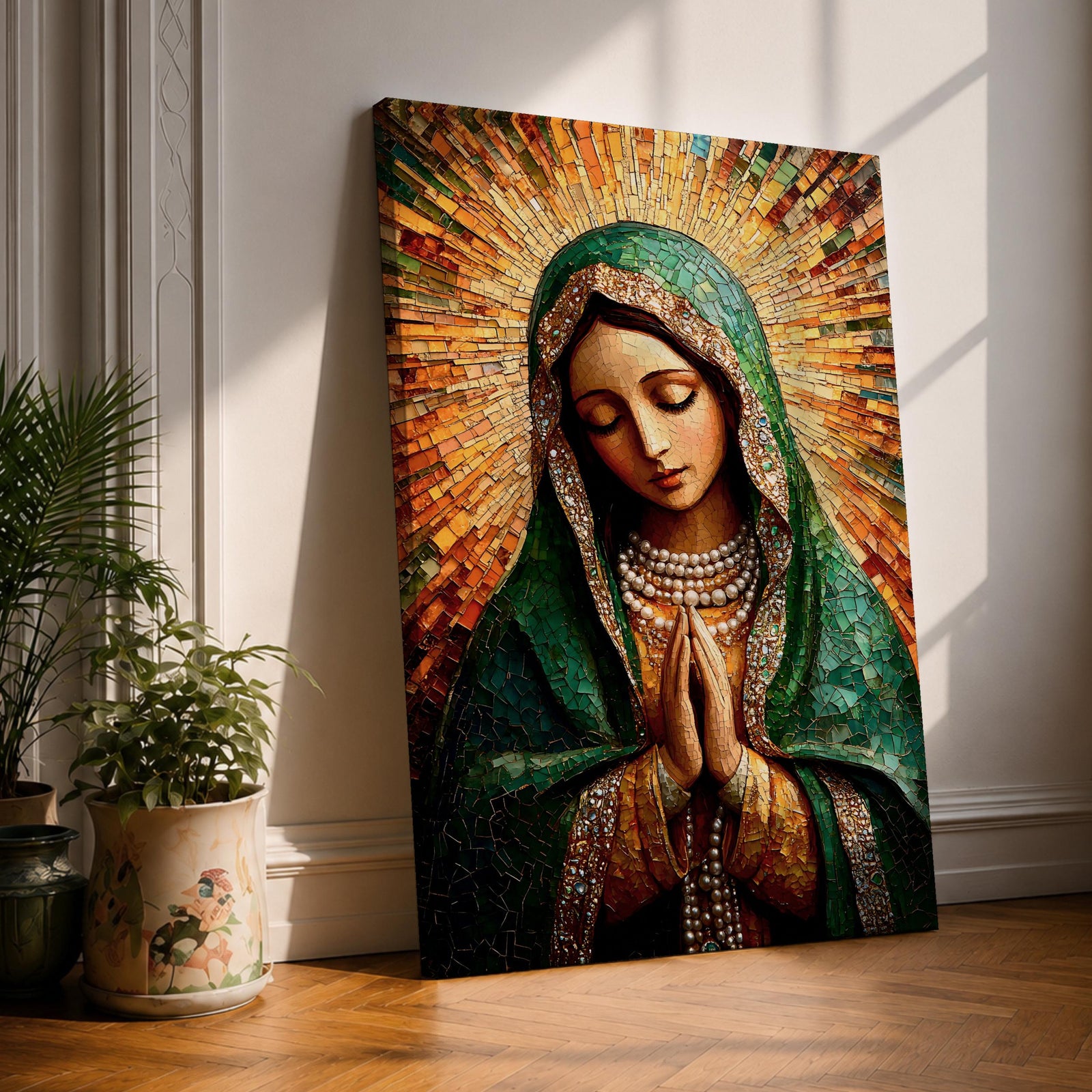 Mosaic style portrait of the Virgin Mary shown with head bowed and hands clasped in prayer, composed of small tile like fragments forming a devotional Catholic image. Radiant rays expand behind her while a detailed veil and necklace are rendered in textured mosaic pieces typical of religious icon artwork.
