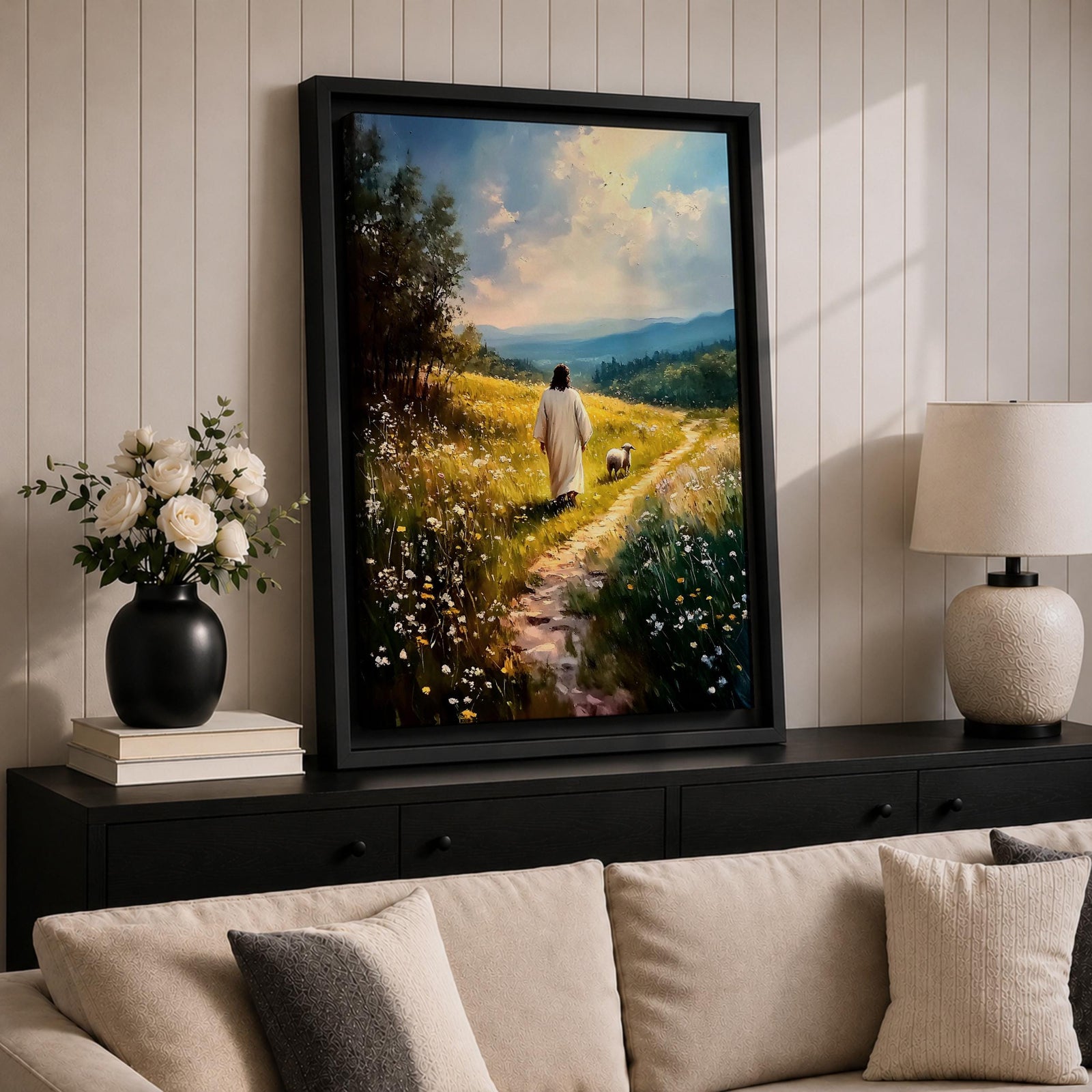 Painting of Jesus walking along a winding path through a sunlit meadow filled with wildflowers while a small lamb walks beside him, with rolling hills and soft clouds in the distance, rendered in a pastoral Christian style that reflects the biblical Good Shepherd and lost lamb theme.