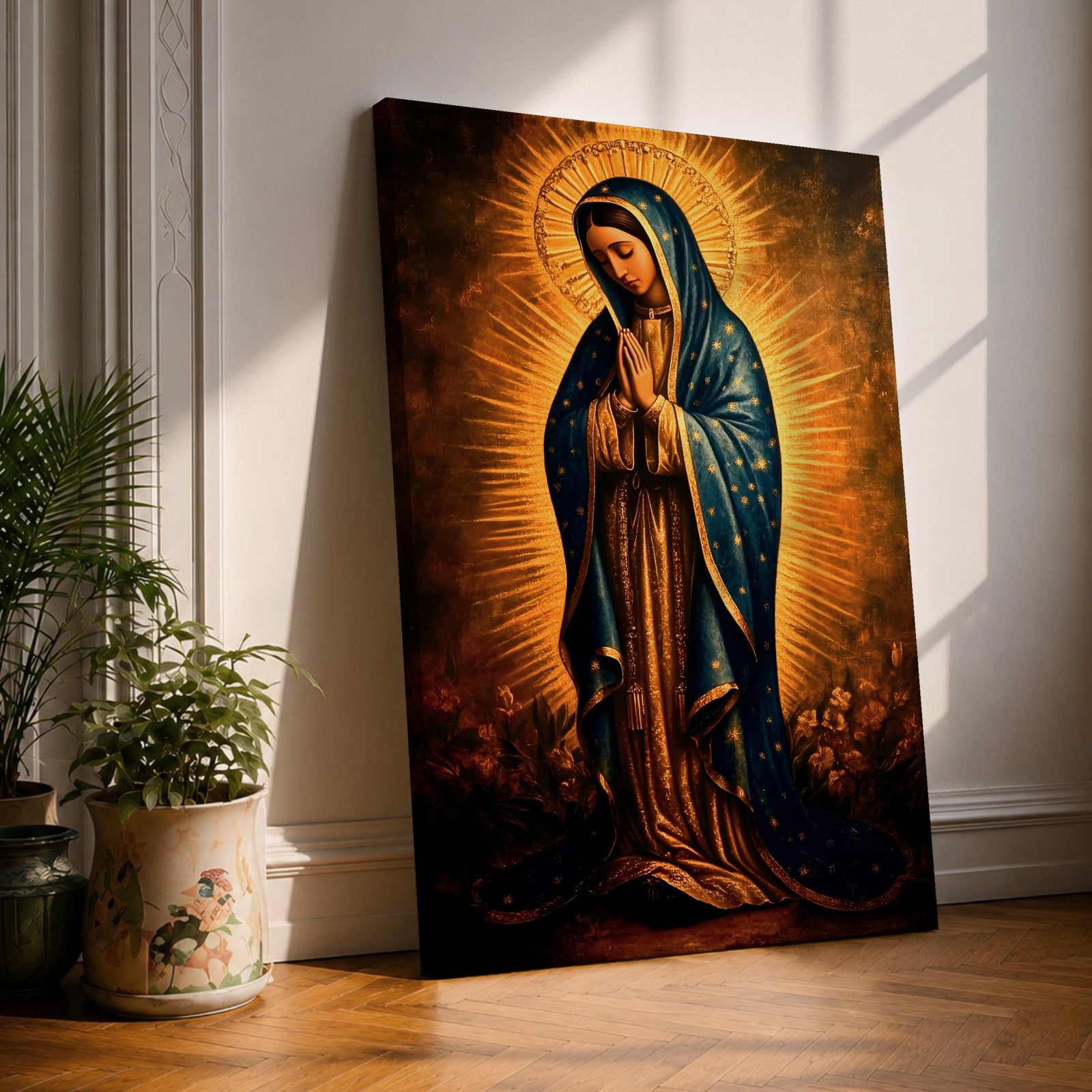 A vintage style framed canvas depicting Our Lady of Guadalupe with a radiant golden halo, wearing a blue cloak adorned with stars, standing in prayer with a serene expression. The artwork highlights traditional Mexican Catholic iconography with rich, warm tones and intricate detailing.
