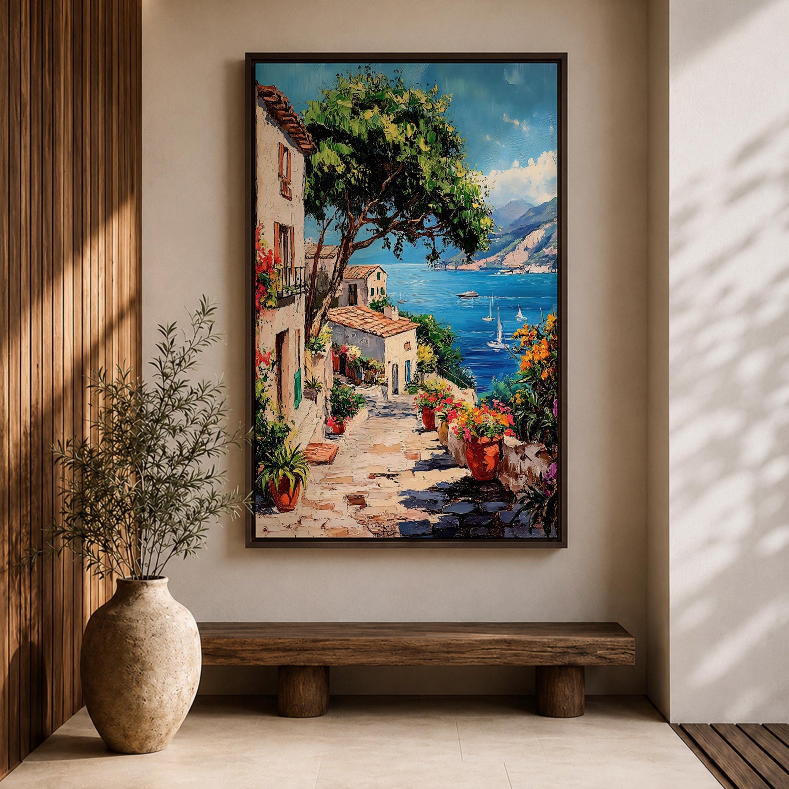 This artwork depicts a vibrant Italian village scene with terracotta-roofed houses, lush greenery, and colorful flowers lining a stone pathway that leads down to a bright blue Mediterranean sea with sailboats and distant mountains, rendered in a realistic style capturing coastal charm.
