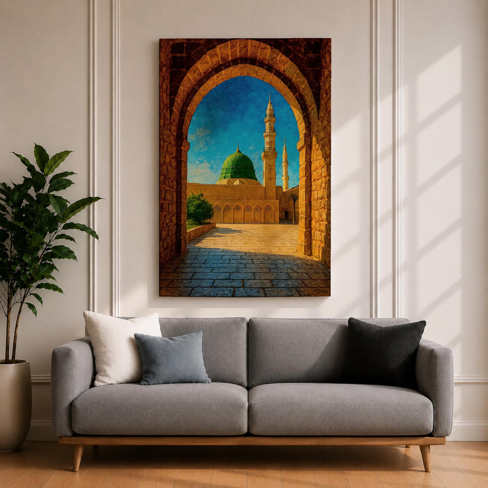 Artwork of Masjid Al Nabawi in Medina viewed through a historic stone archway with the iconic green dome and tall mosque minarets rising under a bright blue sky.