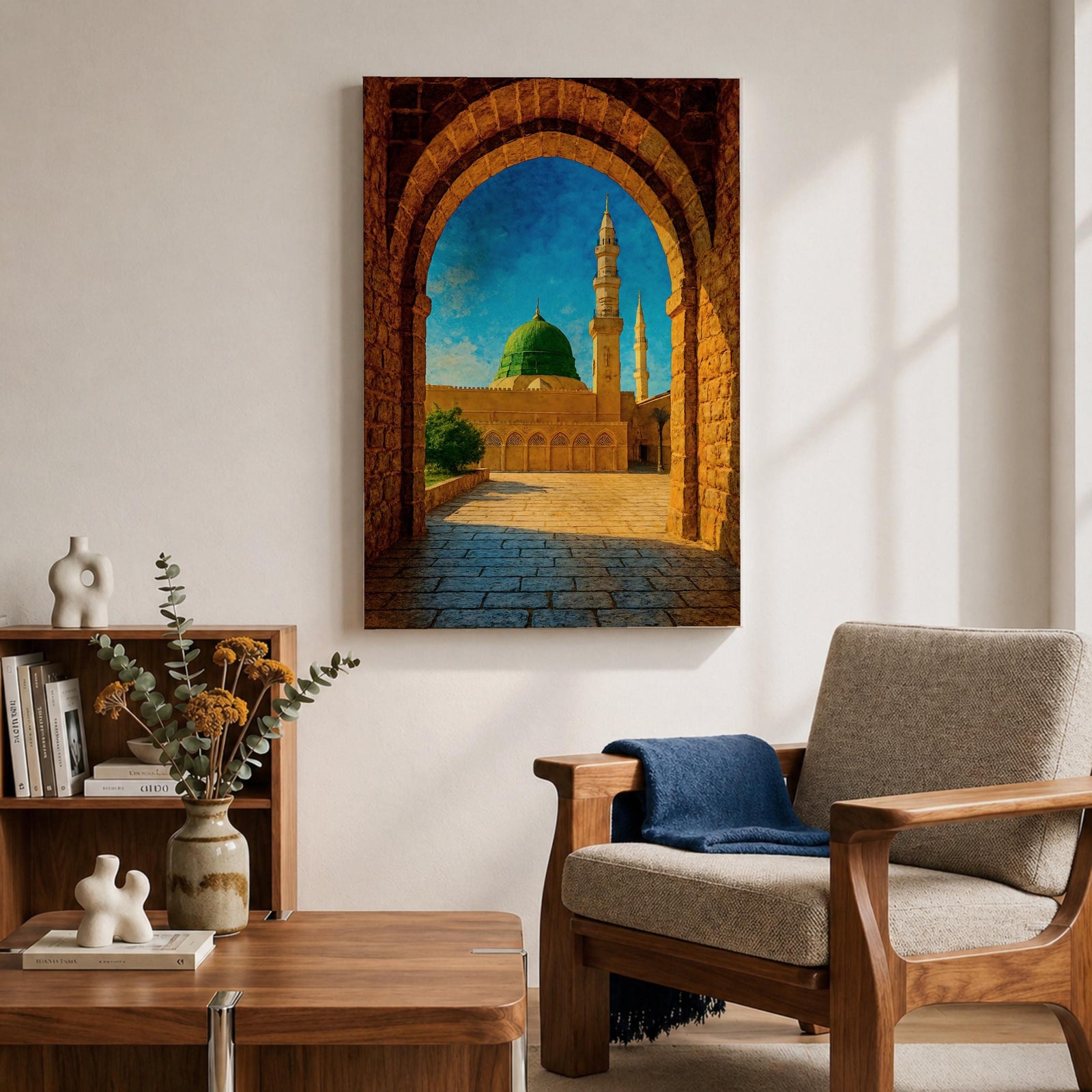 Artwork of Masjid Al Nabawi in Medina viewed through a historic stone archway with the iconic green dome and tall mosque minarets rising under a bright blue sky.