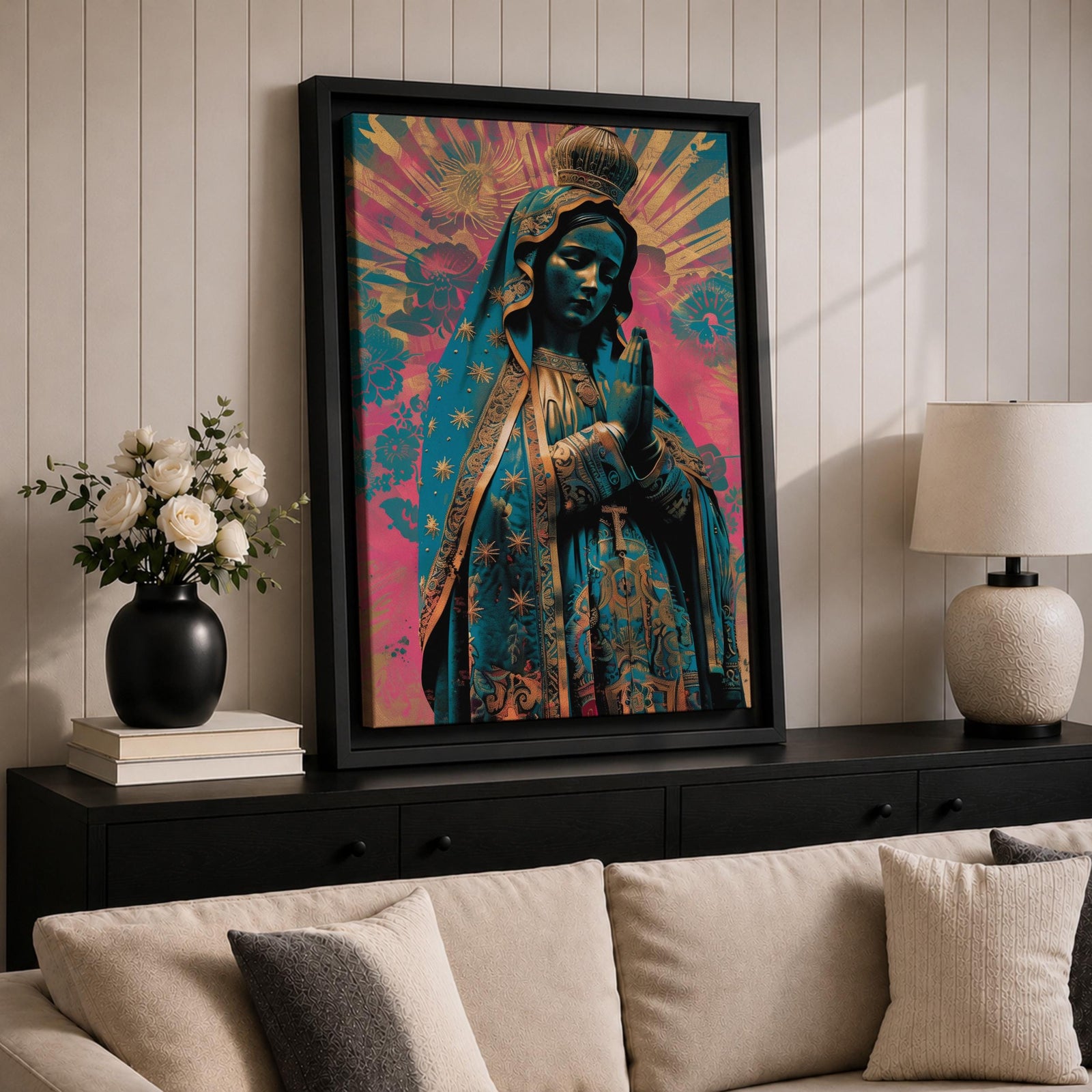 Retro style illustration of the Virgin Mary with hands folded in prayer, wearing a decorated blue mantle with star patterns and a crown, surrounded by radiant rays and floral graphic elements in bold pink and teal colors, rendered in a modern pop inspired Madonna composition with ornamental details.