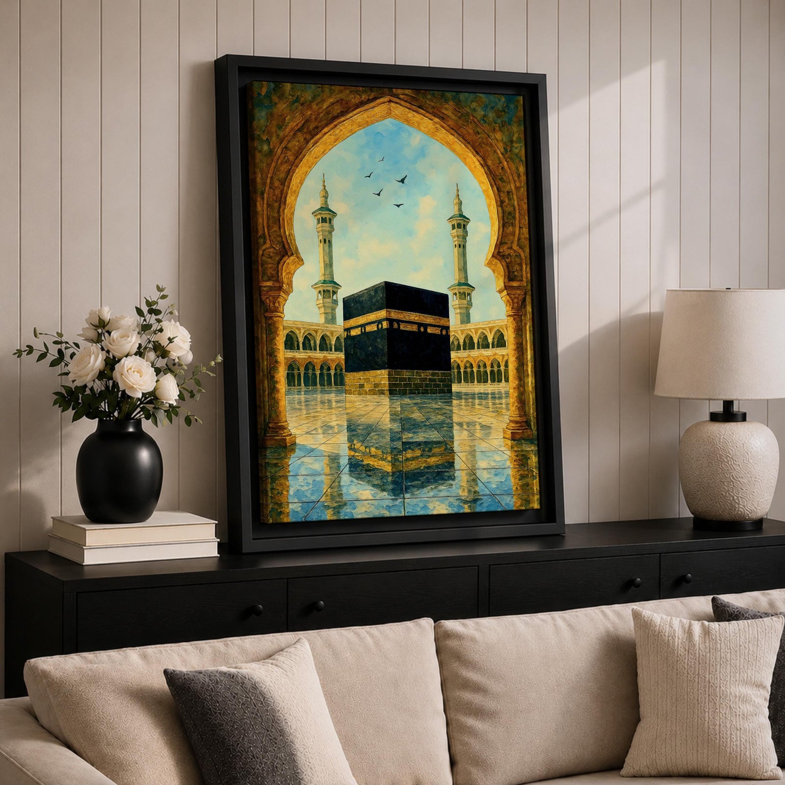 Artwork of the Kaaba in Masjid Haram viewed through an ornate Moorish arch with arabesque detailing, twin mosque minarets rising above the reflective courtyard beneath a soft blue sky.