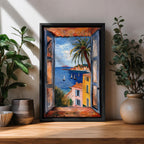 A framed canvas artwork depicting a coastal window view overlooking a Mediterranean ocean scene with sailboats on blue water, colorful buildings with terracotta roofs, and a palm tree, rendered in a realistic style capturing the serene seaside landscape.