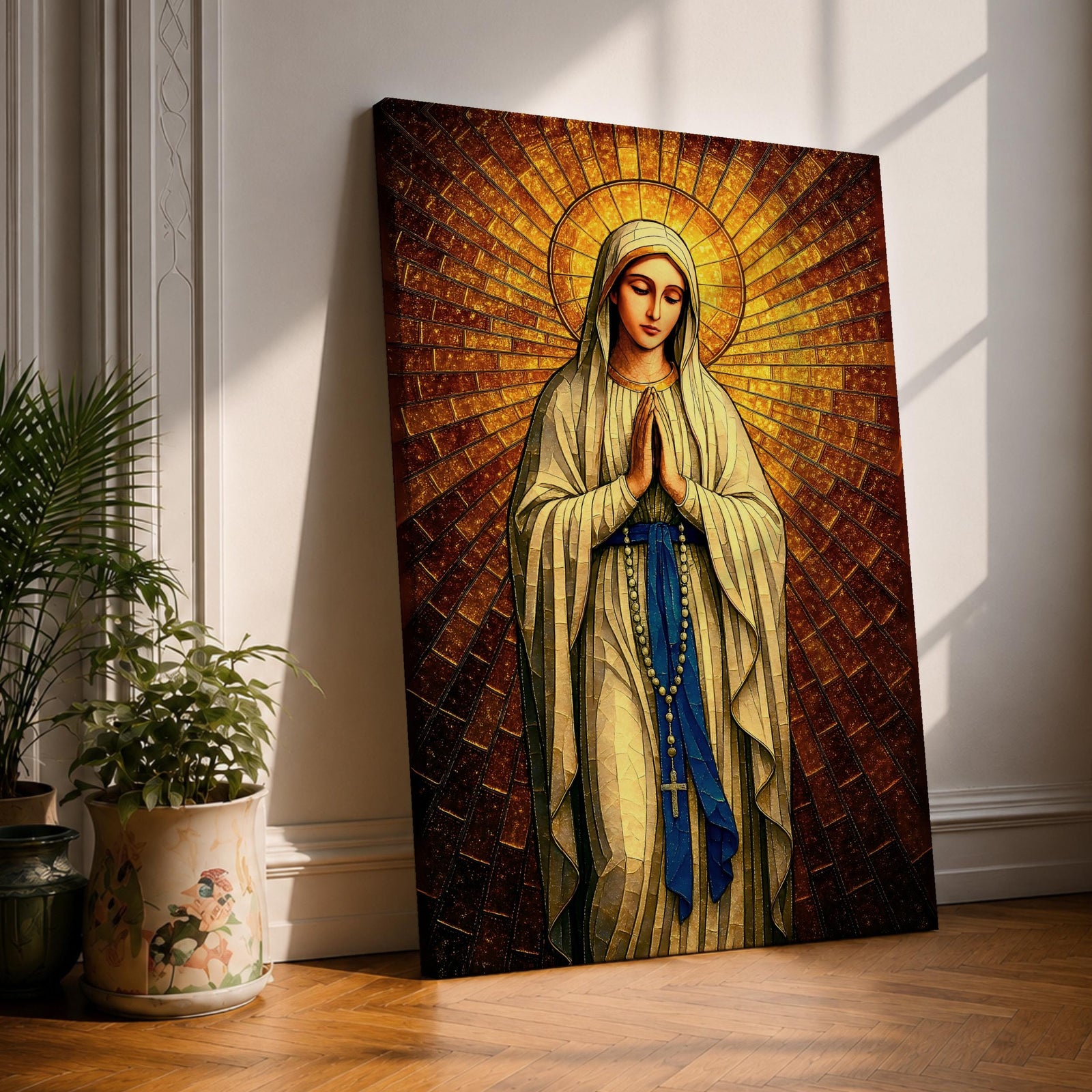 A stained glass style artwork depicting Our Lady of Fatima standing with hands clasped in prayer, wearing a flowing robe and a blue sash with rosary beads. The background features radiant golden mosaic tiles arranged in a halo pattern emphasizing the figure’s serene expression and sacred presence.