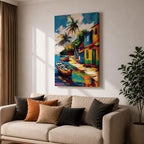 A vibrant painting of a Caribbean village featuring colorful houses along a waterfront with two boats docked near the shore and tall palm trees under a bright sky. The style is bold and lively with strong brushstrokes and vivid colors, capturing a tropical coastal landscape scene.