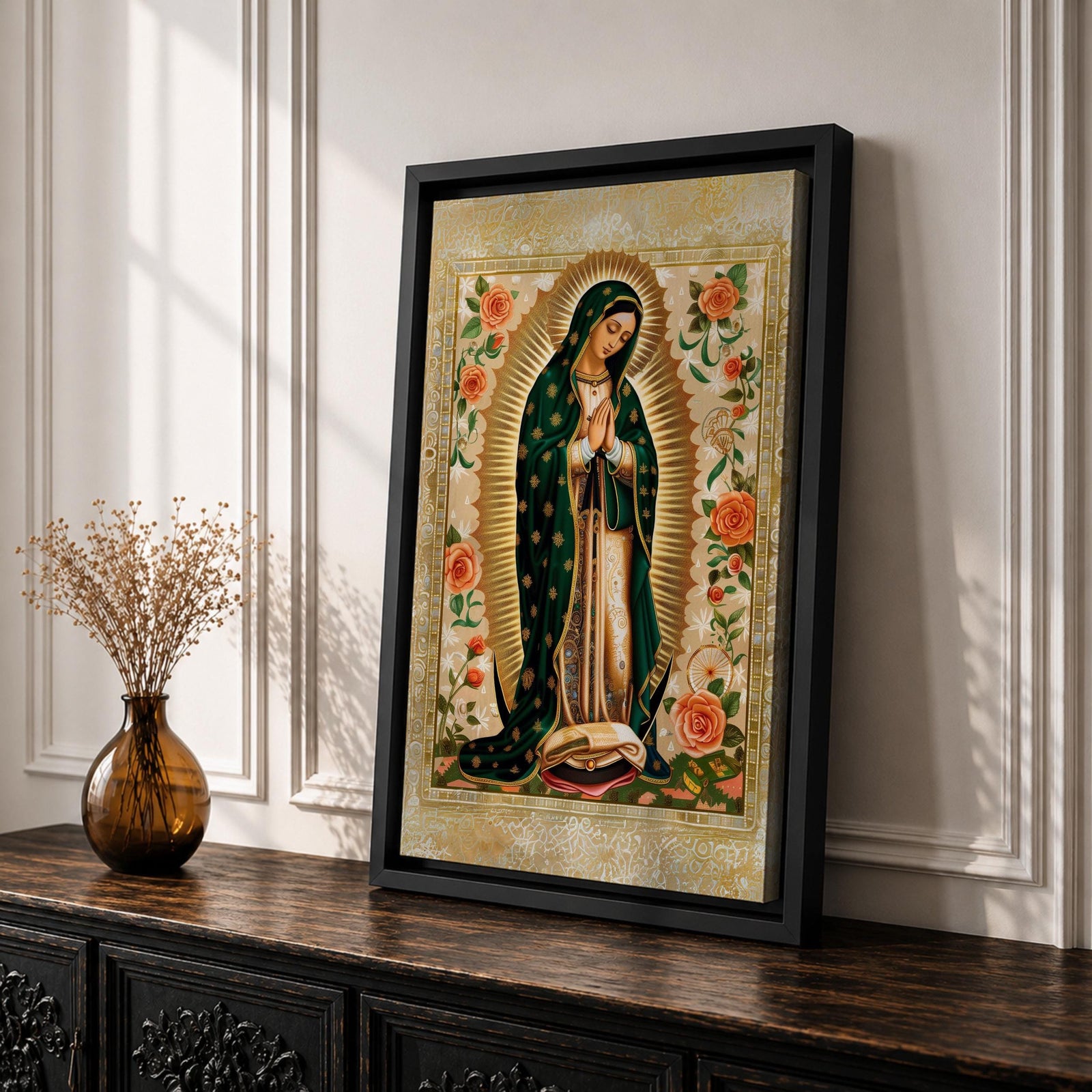 Decorative devotional illustration of Our Lady of Guadalupe standing in prayer with hands folded, wearing a green mantle with golden stars and a pink robe, surrounded by radiant golden rays and an ornate border of blooming roses and floral motifs in a traditional Mexican Catholic icon style.