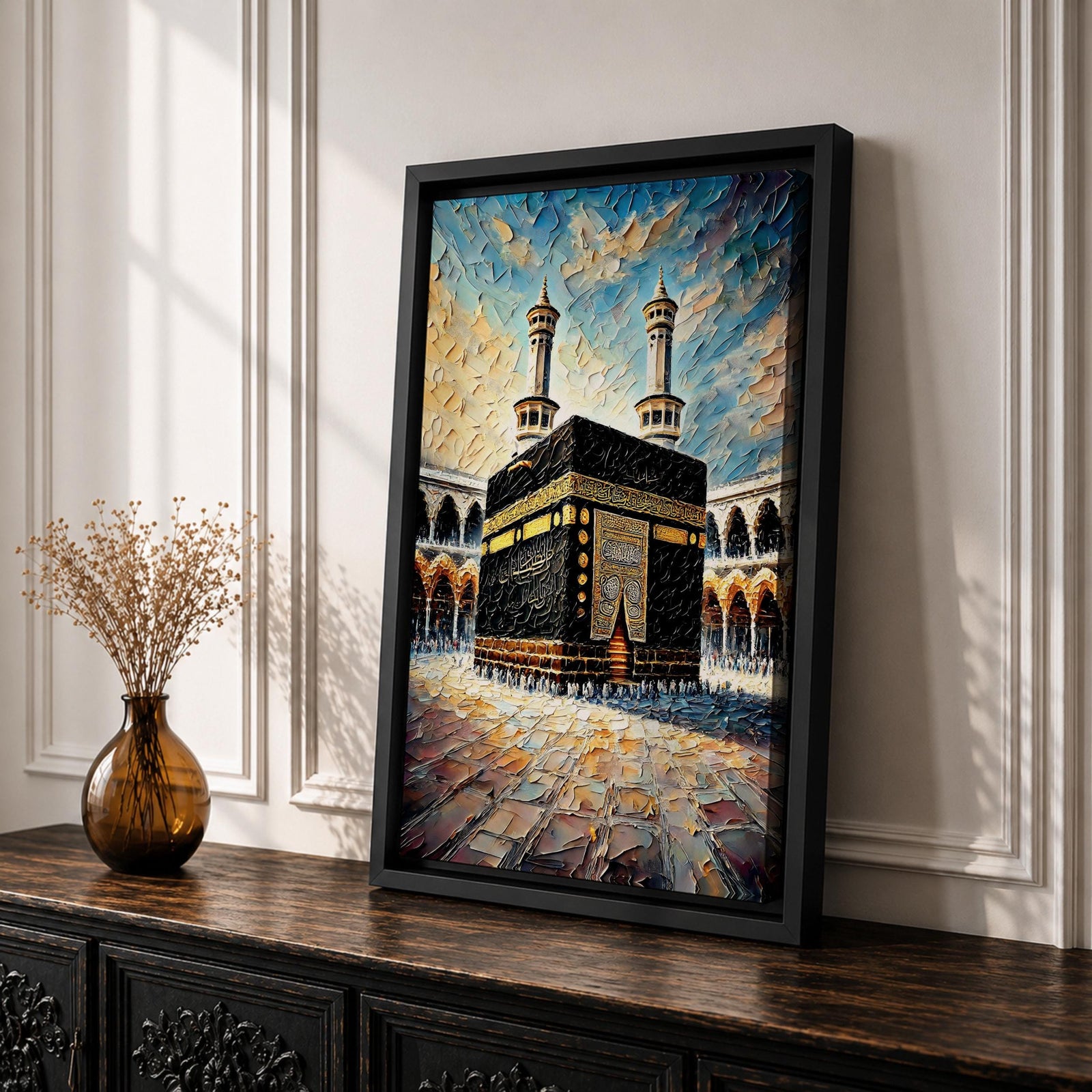 Textured painting of the Kaaba at Masjid Al Haram in Mecca showing the black cube with gold calligraphy bands centered in the mosque courtyard, surrounded by arches and two tall minarets under a dramatic blue sky rendered with thick palette knife textures.