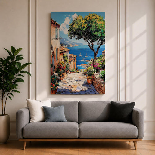A vibrant framed canvas painting depicting a charming coastal village with stone-paved streets, terracotta rooftops, lush greenery, colorful flowers, and sailboats on a deep blue sea under a clear sky, rendered in a detailed, realistic style capturing Mediterranean summer ambiance.