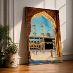 Watercolor style artwork showing the Kaaba at Masjid Al Haram in Mecca framed through a large golden mosque arch, with pilgrims gathered around the courtyard and two tall minarets rising against a clear blue sky.