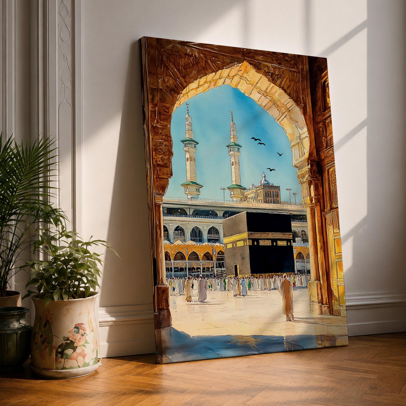 Watercolor style artwork showing the Kaaba at Masjid Al Haram in Mecca framed through a large golden mosque arch, with pilgrims gathered around the courtyard and two tall minarets rising against a clear blue sky.
