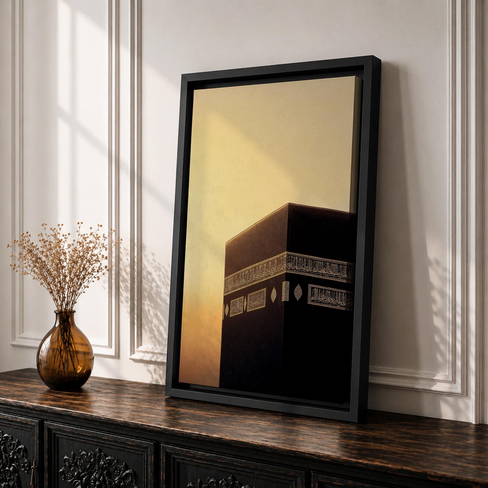 Minimalist artwork of the Kaaba at Masjid Al Haram in Mecca showing the black cubic shrine with gold calligraphy bands against a dramatic golden sunset sky and soft clouds.