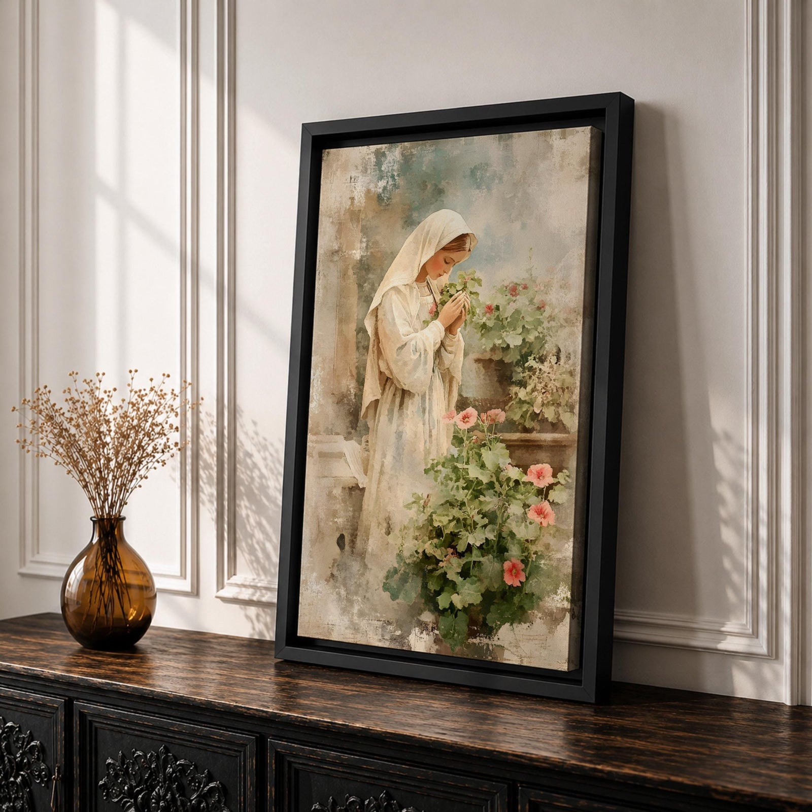 Soft vintage style painting of the Virgin Mary standing in prayer beside blooming garden flowers, wearing a white veil and robe while gently holding a small blossom, surrounded by pastel greenery and delicate pink flowers in a serene devotional garden scene.