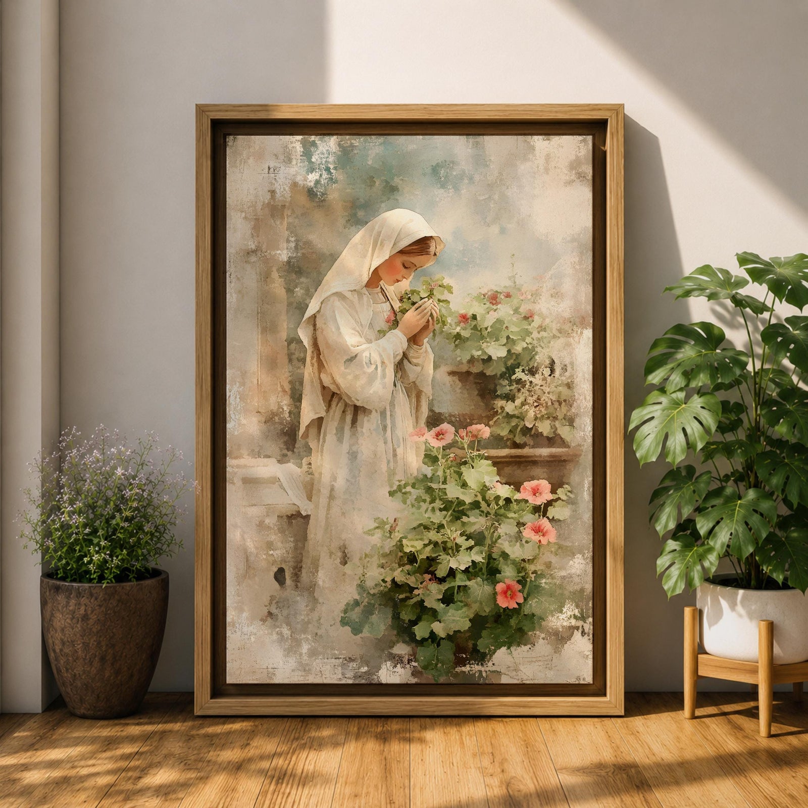 Soft vintage style painting of the Virgin Mary standing in prayer beside blooming garden flowers, wearing a white veil and robe while gently holding a small blossom, surrounded by pastel greenery and delicate pink flowers in a serene devotional garden scene.