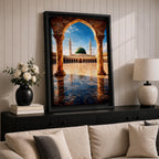 Artwork of Masjid Al Nabawi in Medina showing the iconic green dome and tall minarets framed through a large stone archway with a reflective marble courtyard under a bright blue sky.