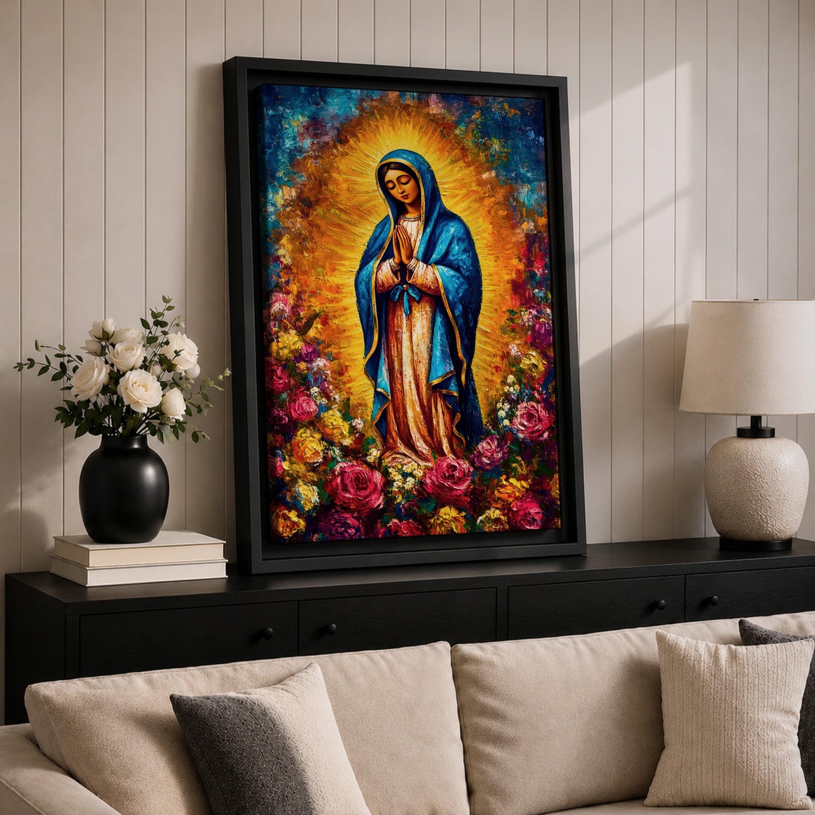 Colorful devotional painting inspired by Our Lady of Guadalupe showing the Virgin Mary standing in prayer with hands folded, wearing a blue mantle and surrounded by a radiant golden halo and vibrant blooming roses forming a rich floral Catholic composition.