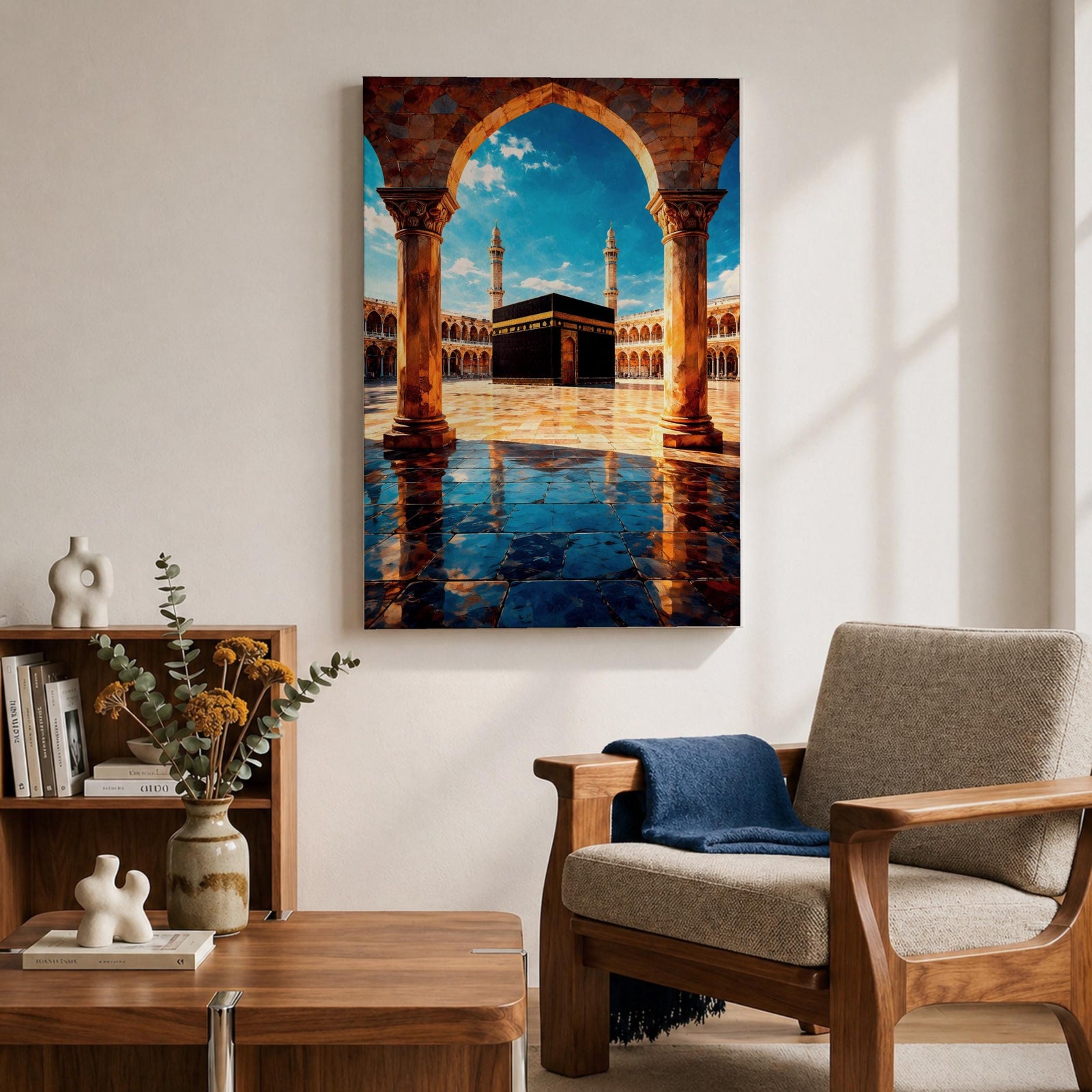 Framed wall art showing the Kaaba at Masjid Al Haram in Mecca viewed through a grand marble archway with columns and reflective courtyard tiles under a bright blue sky.