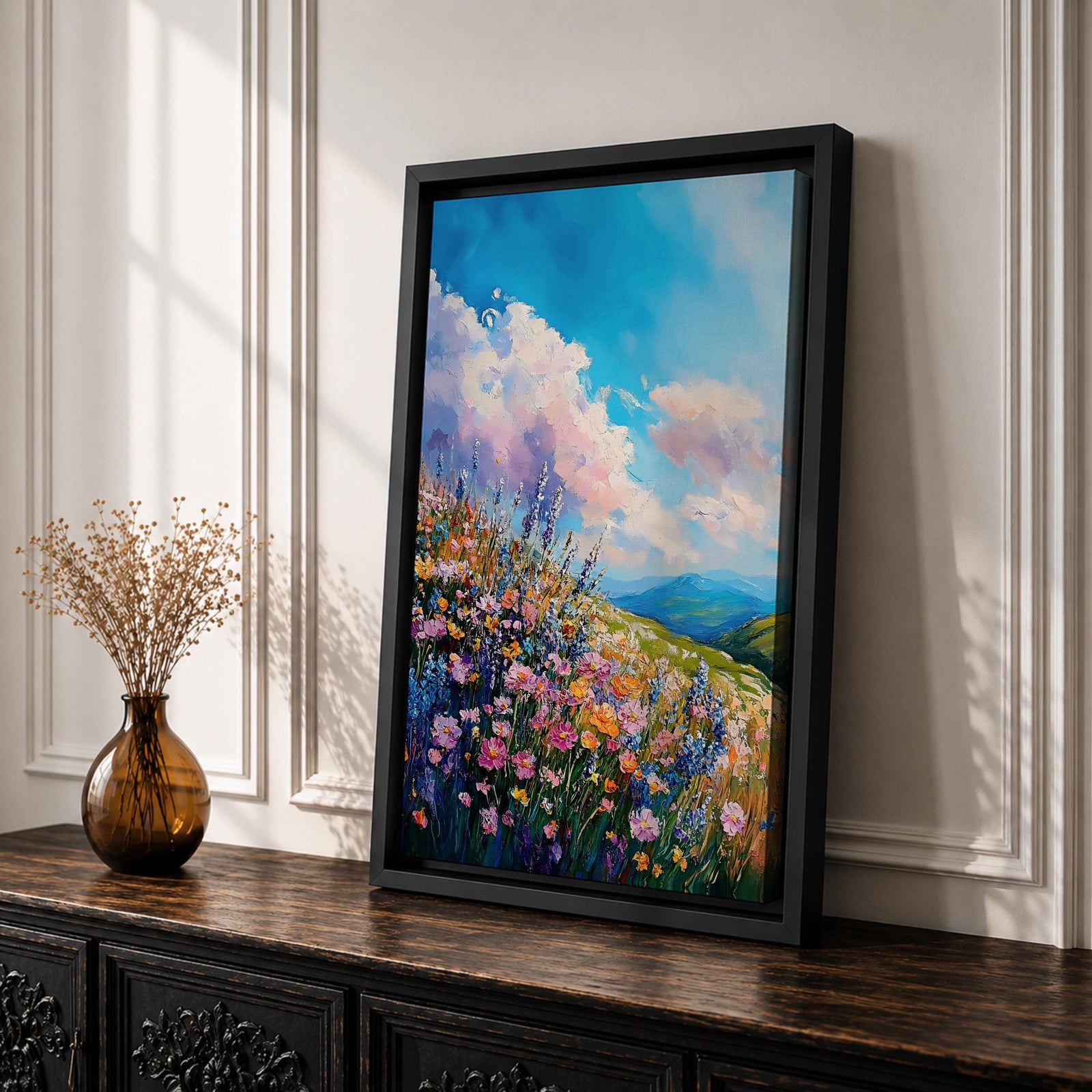 A vibrant impasto painting of a wildflower meadow featuring dense clusters of colorful flowers under a bright blue sky with fluffy clouds. The textured brushstrokes create depth and movement, capturing a lively natural landscape scene with rolling hills in the distance.