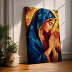 Stained glass style painting of the Virgin Mary shown in profile with head bowed and hands clasped in prayer, wearing a blue mantle and red garment, surrounded by geometric stained glass panels forming a radiant halo like background in a devotional Catholic Marian composition.
