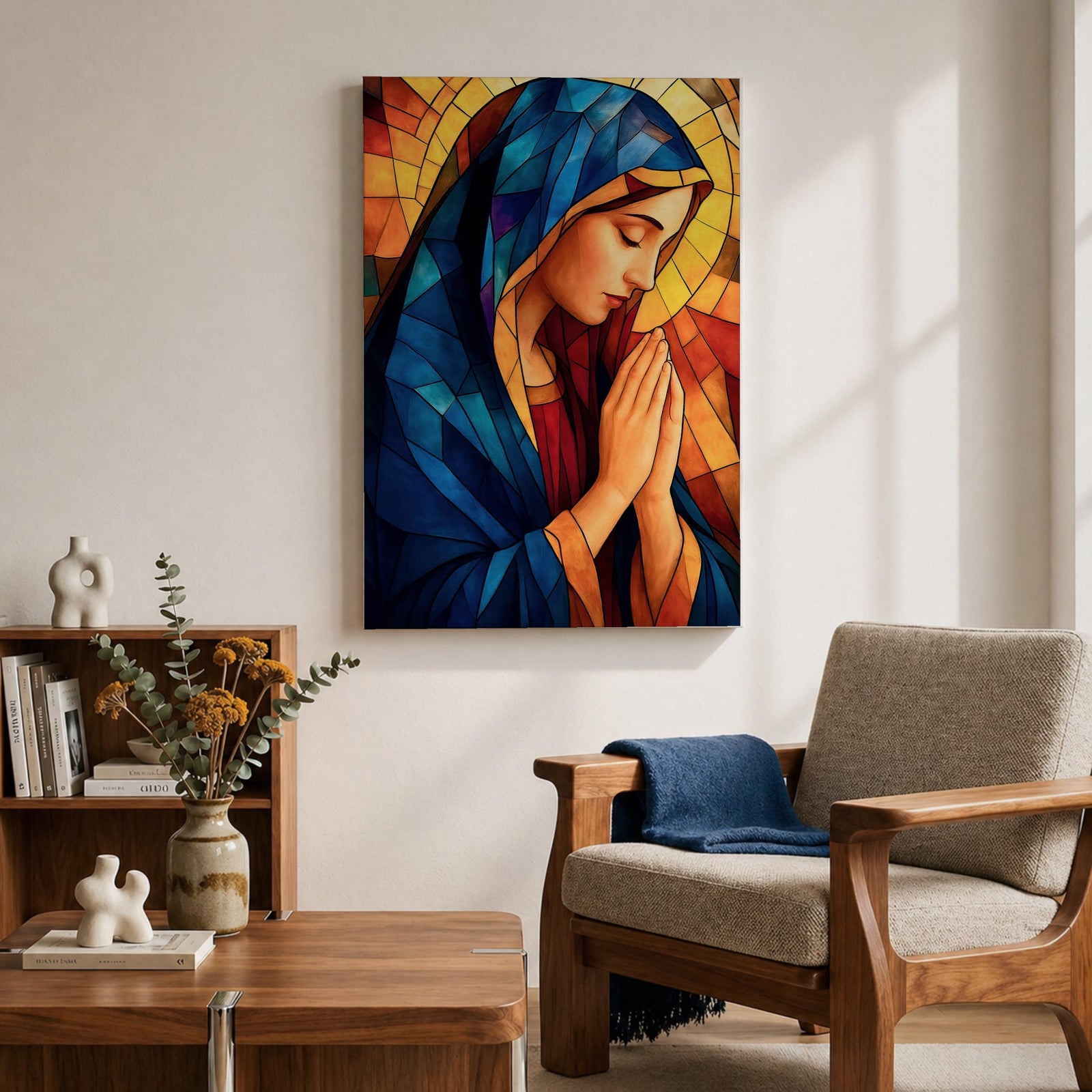 Stained glass style painting of the Virgin Mary shown in profile with head bowed and hands clasped in prayer, wearing a blue mantle and red garment, surrounded by geometric stained glass panels forming a radiant halo like background in a devotional Catholic Marian composition.