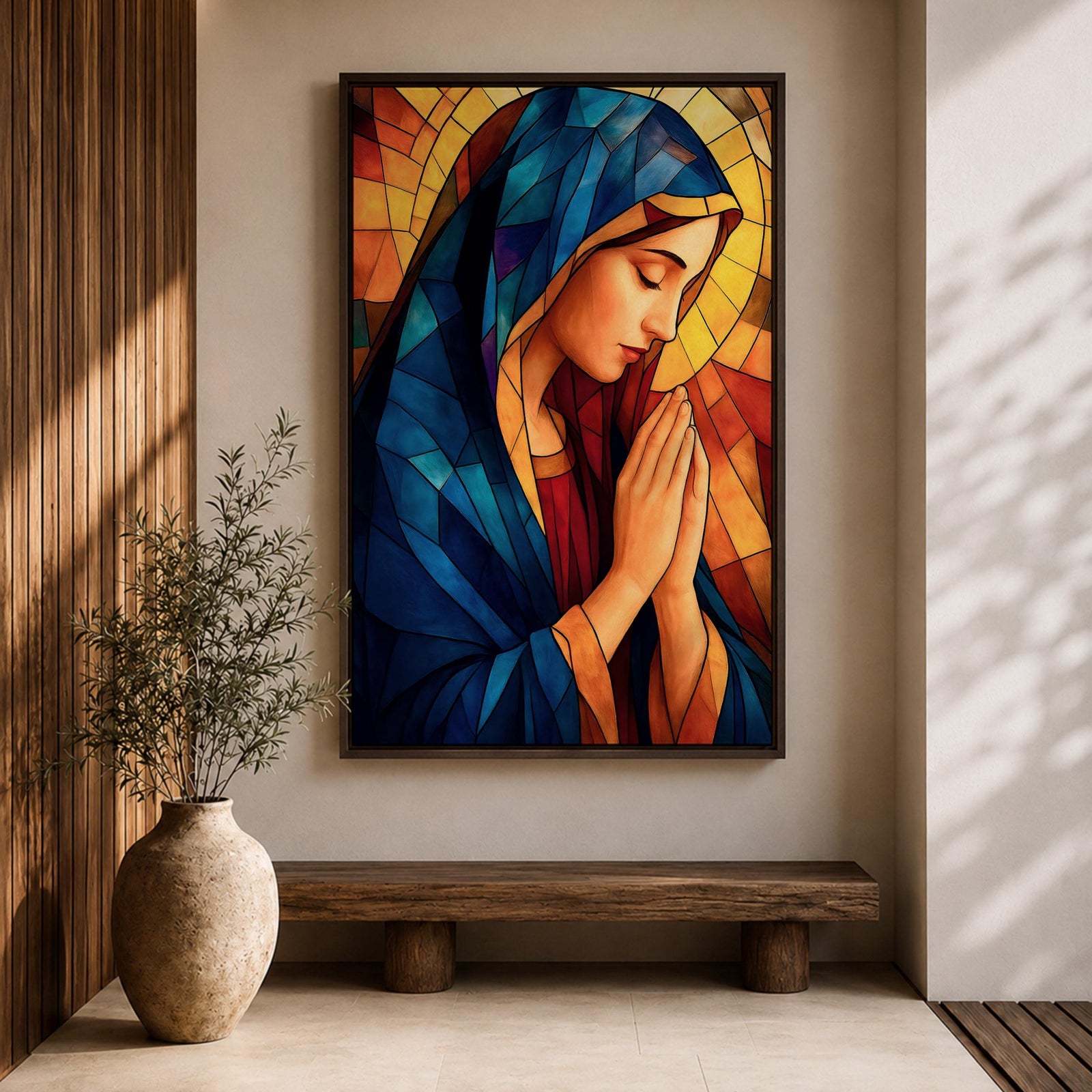Stained glass style painting of the Virgin Mary shown in profile with head bowed and hands clasped in prayer, wearing a blue mantle and red garment, surrounded by geometric stained glass panels forming a radiant halo like background in a devotional Catholic Marian composition.