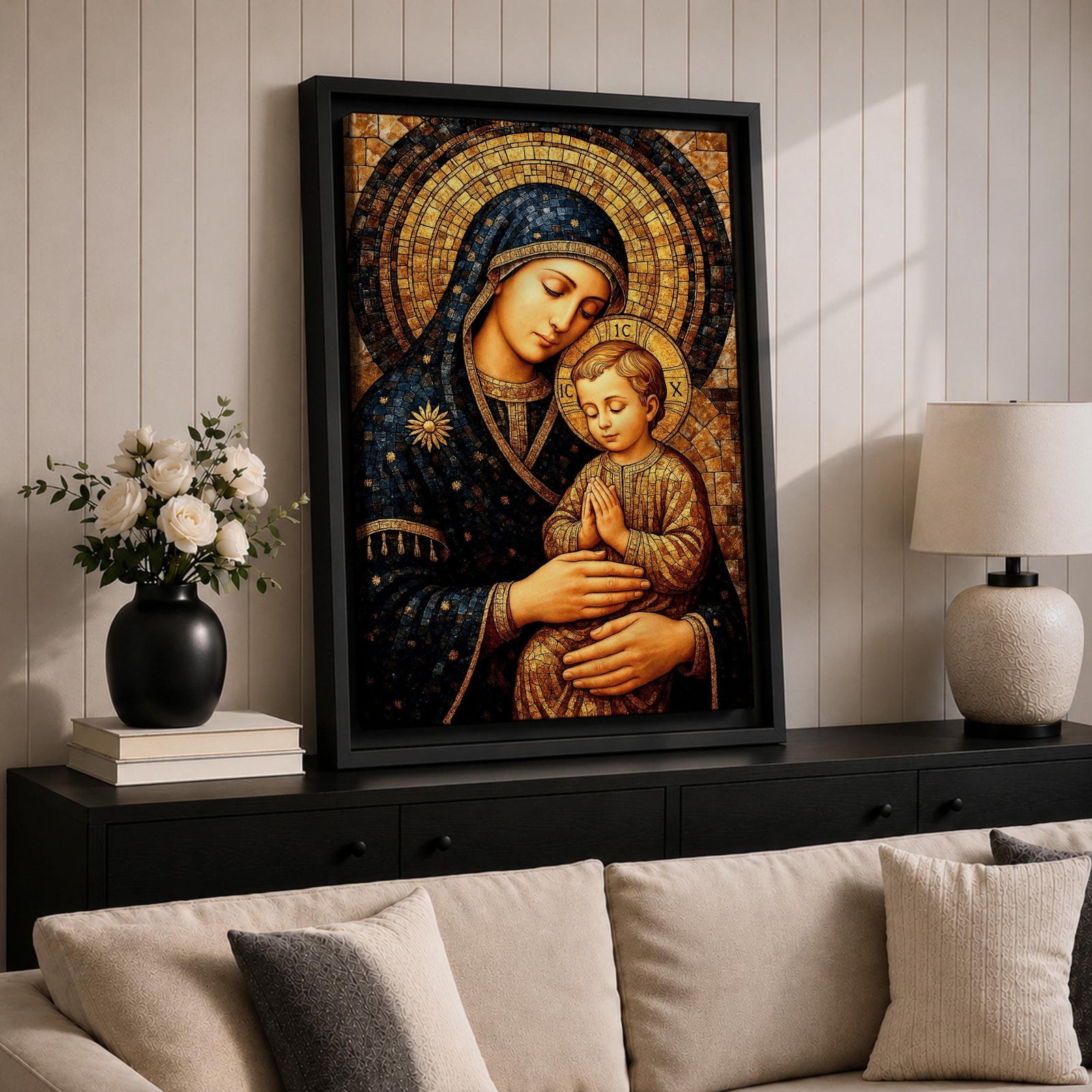 Byzantine style mosaic painting of the Virgin Mary holding the child Jesus, both with heads gently inclined and halos behind them, the child shown with hands clasped in prayer while Mary supports him, rendered with golden mosaic tiles and rich dark blue garments in a traditional Christian icon composition.