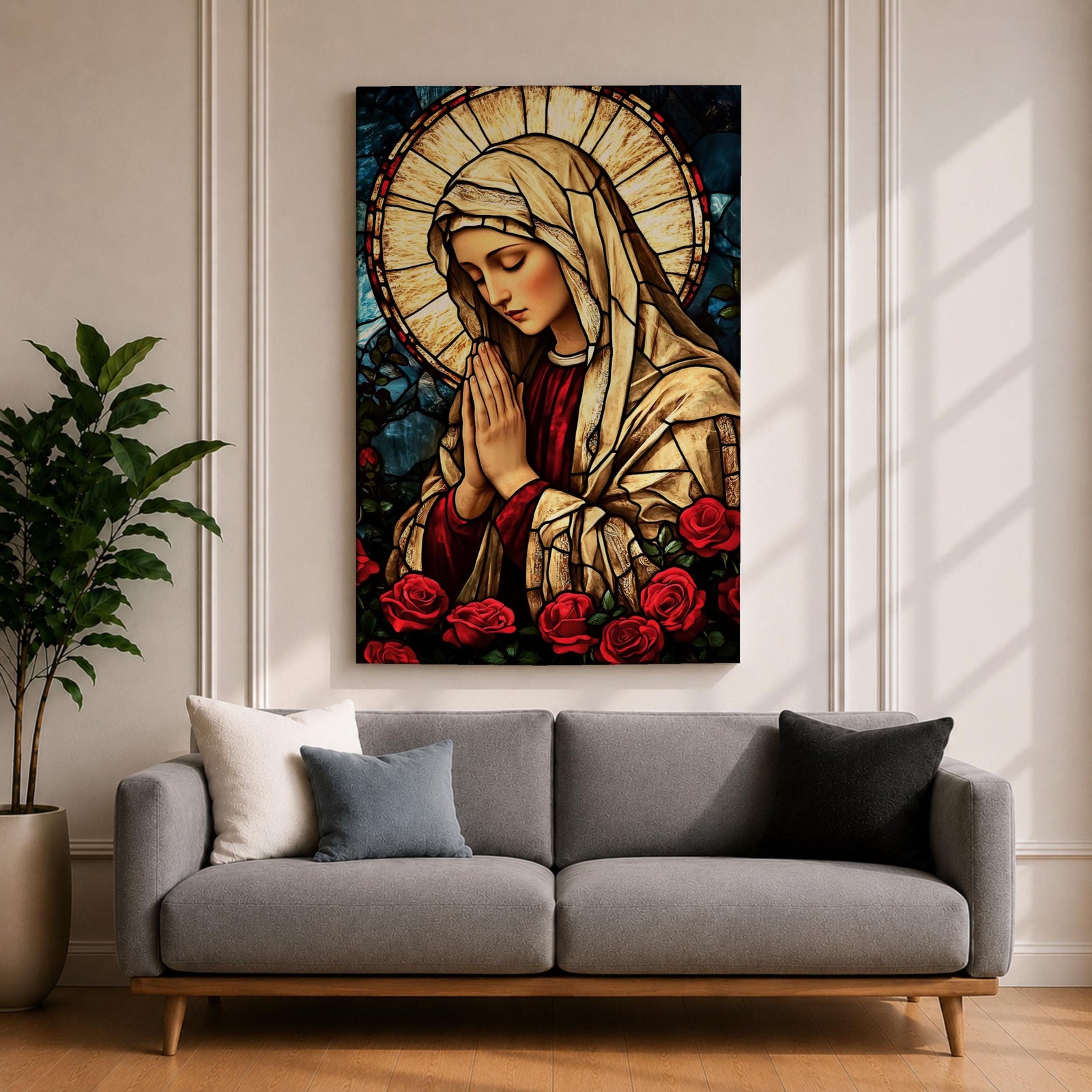 Stained glass style artwork of the Virgin Mary with head bowed and hands clasped in prayer, wearing a cream veil and red garment, surrounded by a radiant circular halo and red roses at the base, rendered with detailed stained glass panels and rich colors in a devotional Marian composition.