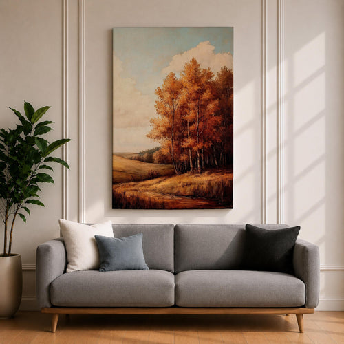 A framed vintage-style painting depicting an autumn landscape with a cluster of orange and yellow fall trees beside a gently rolling meadow under a partly cloudy sky. The artwork captures the serene beauty of a rustic countryside in fall with detailed foliage and soft natural tones.