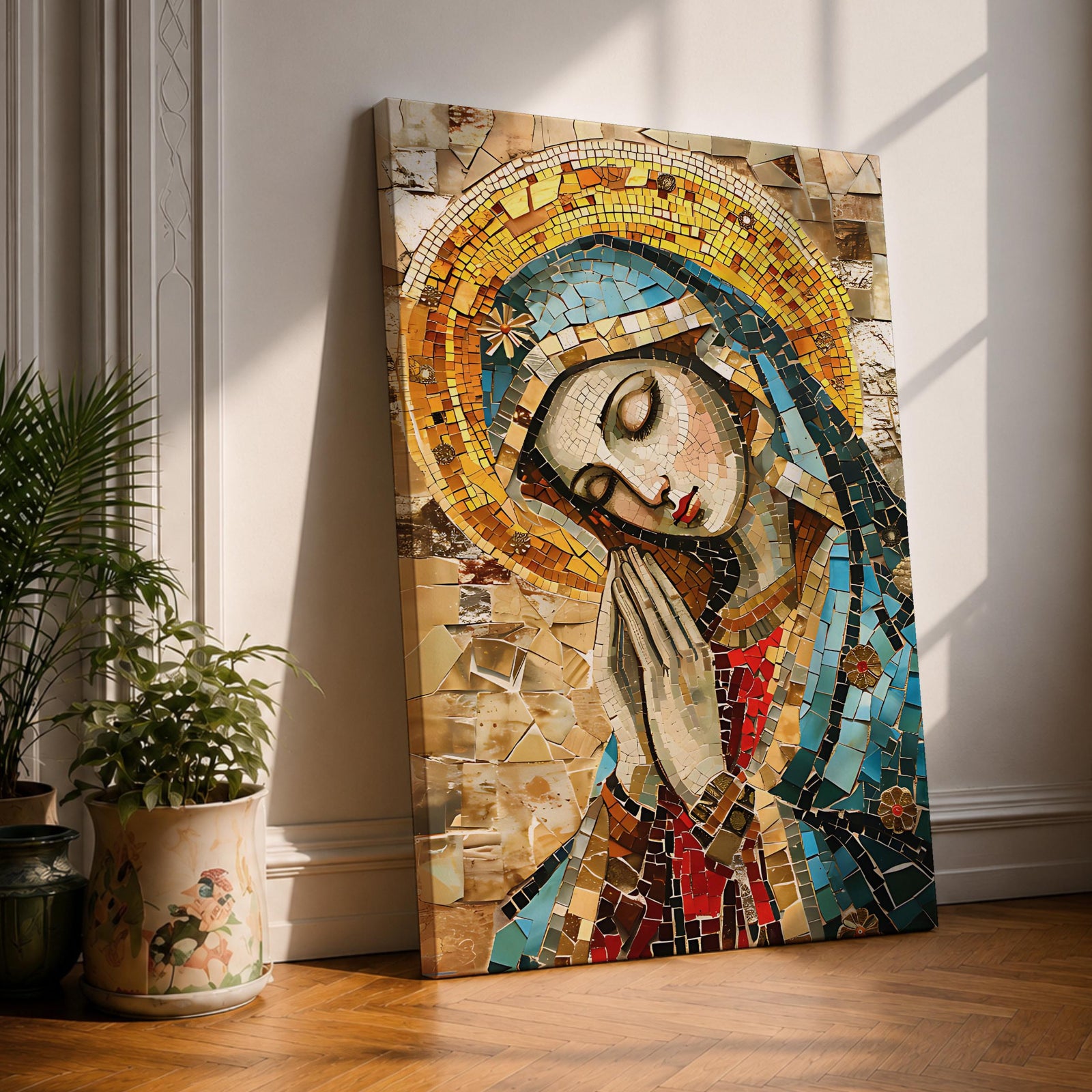 A mosaic-style framed canvas depicting the Virgin Mary with hands clasped in prayer and eyes closed, wearing a blue mantle and golden halo, composed of small colored tiles forming a detailed religious portrait in a mosaic art style.