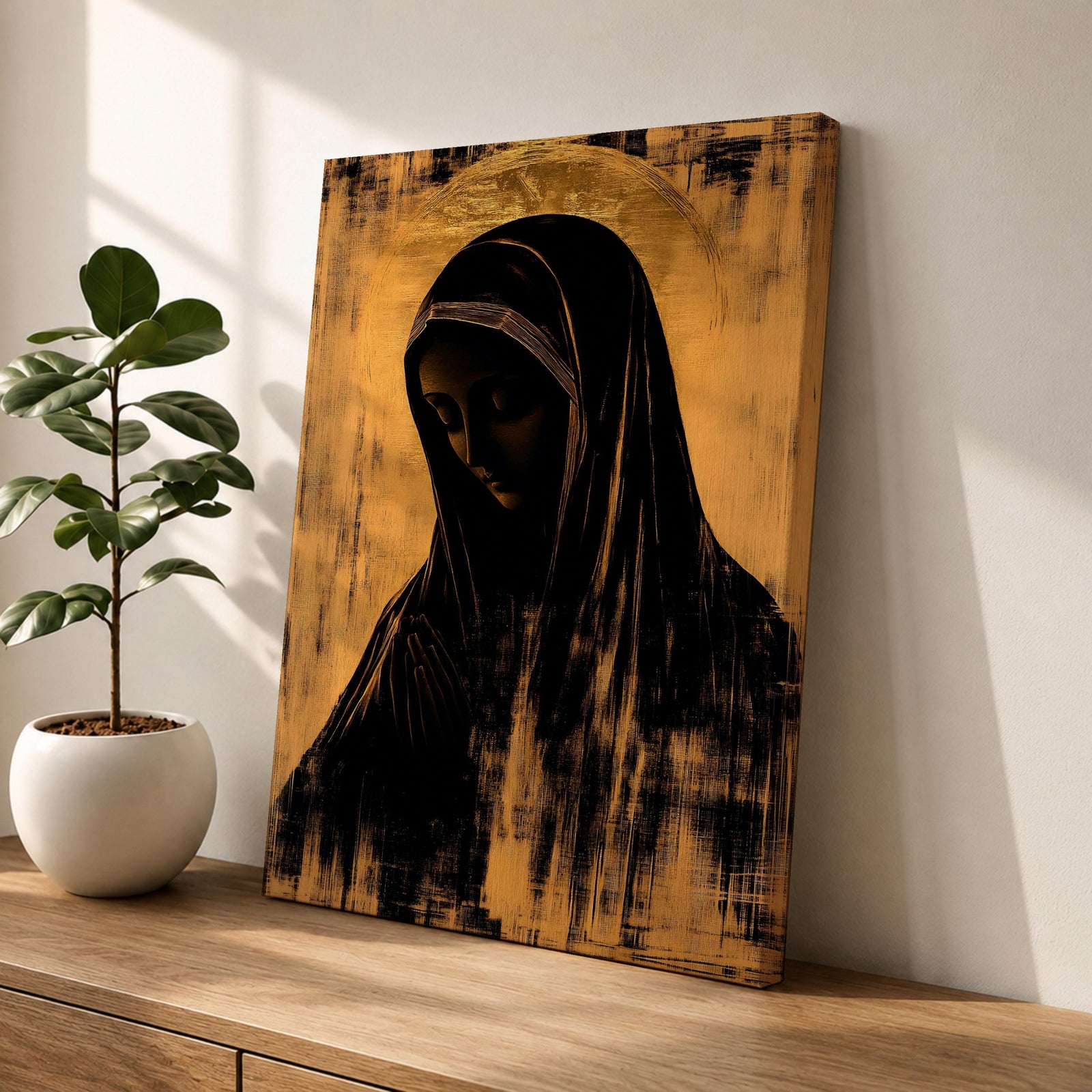 A vintage-style framed canvas wall art depicting a silhouette of the Virgin Mary in a prayerful pose with a halo behind her head. The artwork uses a distressed texture effect with dark and warm tones, emphasizing a classic religious theme in a minimalist silhouette style.