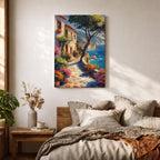 This artwork depicts a Mediterranean coastal scene featuring a charming seaside pathway lined with vibrant flowers and rustic buildings. The textured brushstrokes create a lively impressionistic landscape with a tree in the foreground and boats floating on the blue sea, capturing the essence of coastal tranquility.