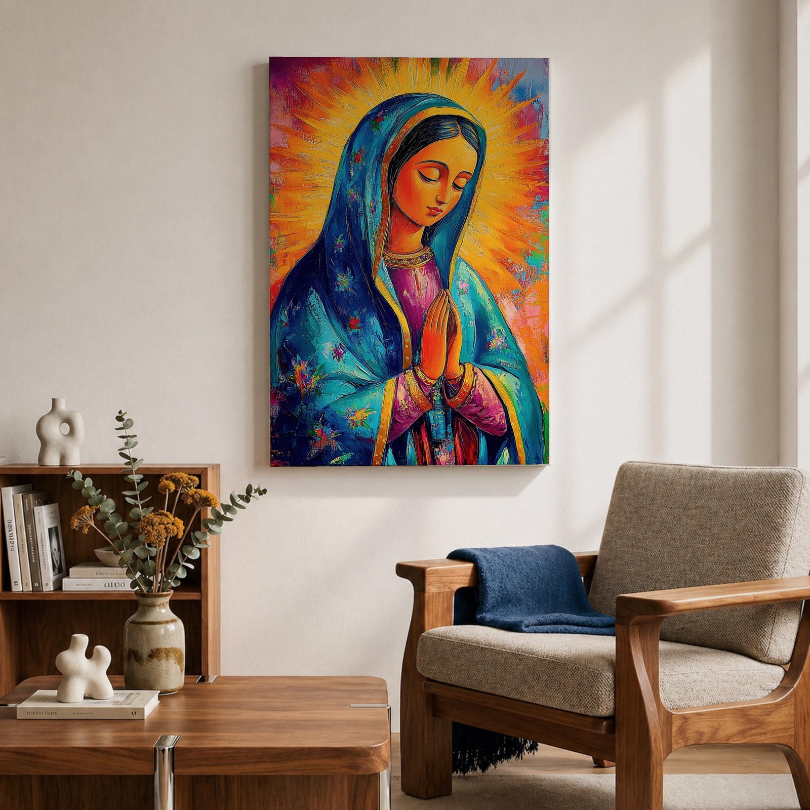 Colorful devotional painting of Our Lady of Guadalupe shown with hands clasped in prayer, wearing a blue star covered mantle over a rose dress while radiant golden rays form a glowing halo behind her figure. The composition presents the Virgin Mary in a vibrant painterly style with bold brushstrokes and centered sacred portrait.