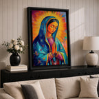 Colorful devotional painting of Our Lady of Guadalupe shown with hands clasped in prayer, wearing a blue star covered mantle over a rose dress while radiant golden rays form a glowing halo behind her figure. The composition presents the Virgin Mary in a vibrant painterly style with bold brushstrokes and centered sacred portrait.