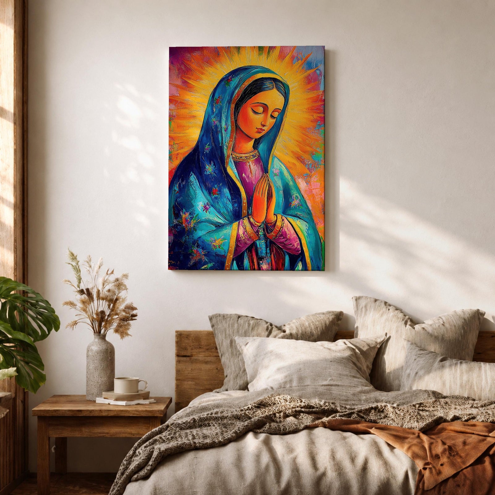Colorful devotional painting of Our Lady of Guadalupe shown with hands clasped in prayer, wearing a blue star covered mantle over a rose dress while radiant golden rays form a glowing halo behind her figure. The composition presents the Virgin Mary in a vibrant painterly style with bold brushstrokes and centered sacred portrait.