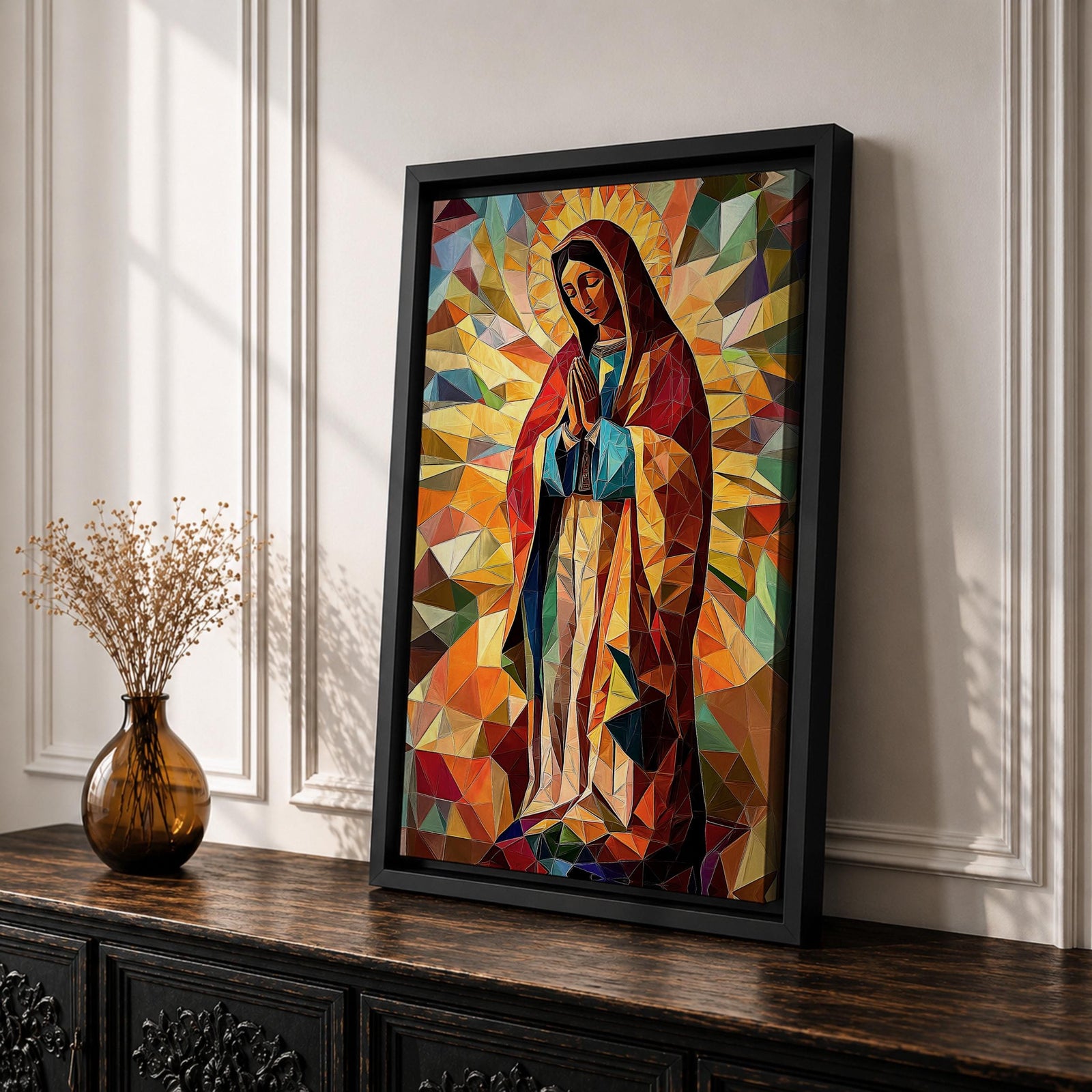 Geometric mosaic style depiction of Our Lady of Guadalupe shown standing in prayer with hands joined, surrounded by radiant golden halo rays and colorful angular shapes forming a stained glass inspired composition that highlights the Virgin Mary in a modern geometric Catholic devotional design.