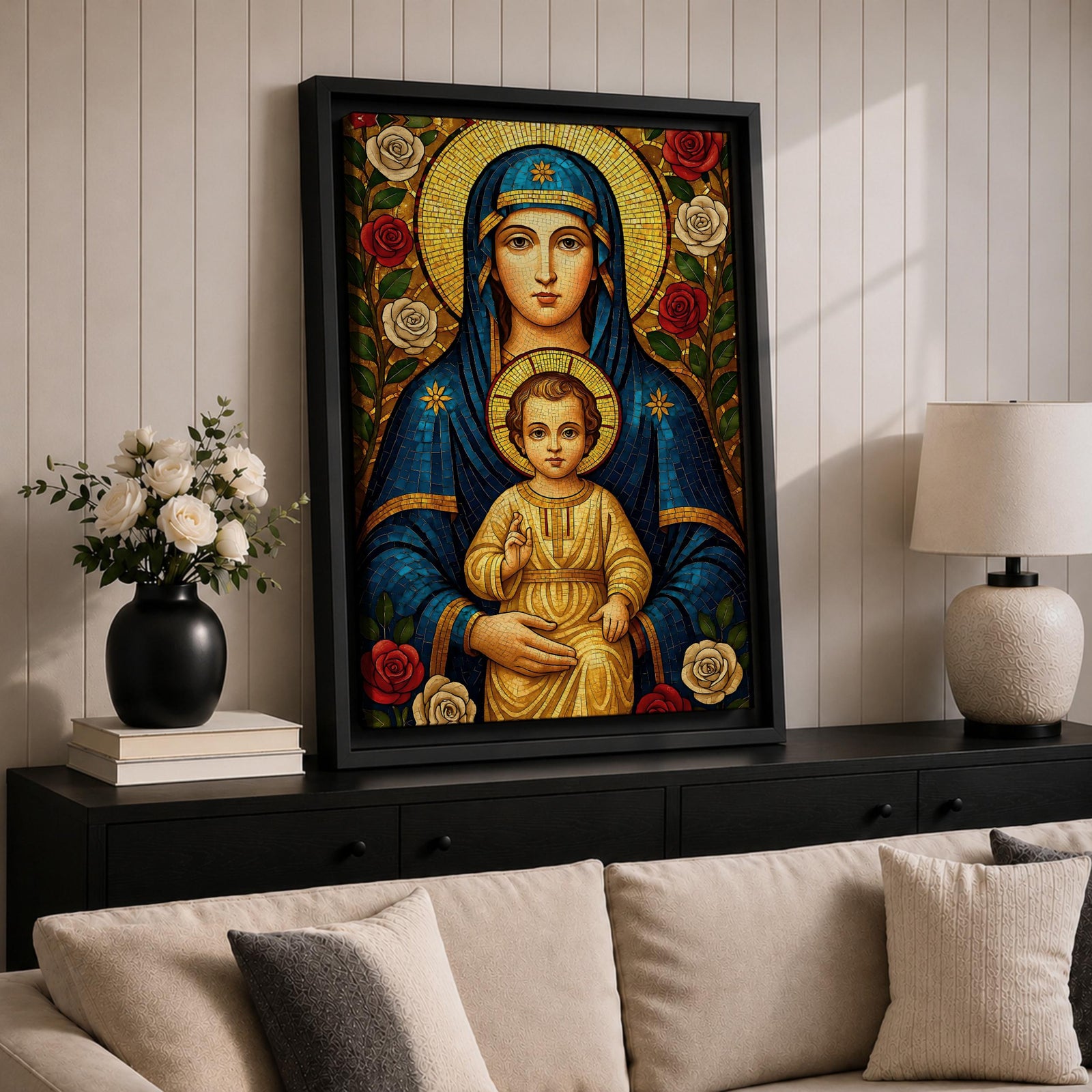 Mosaic icon style artwork of the Virgin Mary holding the child Jesus, both figures shown with golden halos while the infant Christ raises his hand in a blessing gesture, surrounded by red and white roses and intricate mosaic tesserae forming a traditional Catholic Madonna and Child composition.
