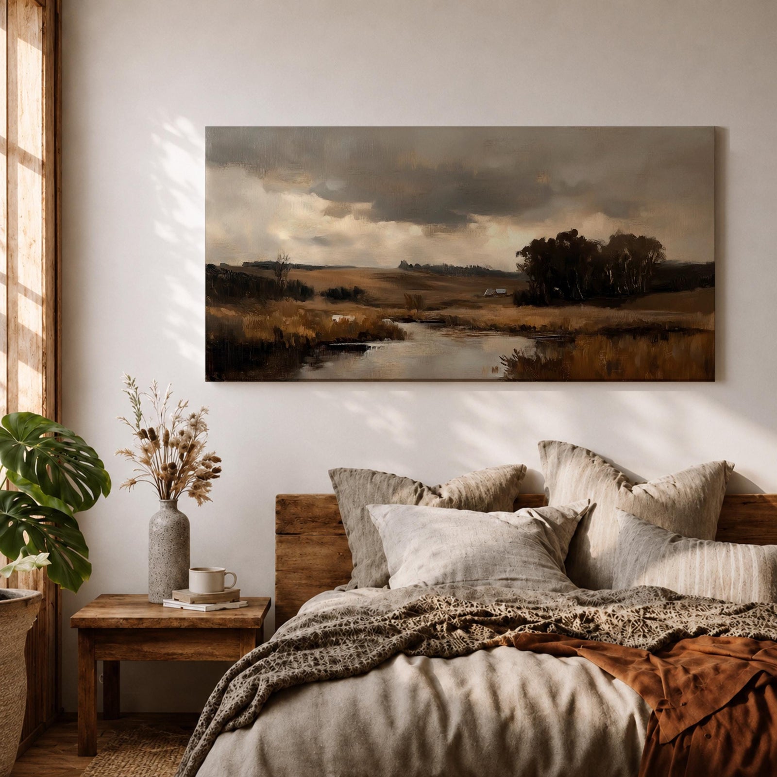 A panoramic countryside river landscape painting featuring a calm winding stream flowing through open rural fields with tall golden grasses and a distant farmhouse near a cluster of dark trees beneath a dramatic cloudy sky. The scene uses earthy browns and muted greens with soft painterly brushstrokes capturing a quiet pastoral prairie setting.