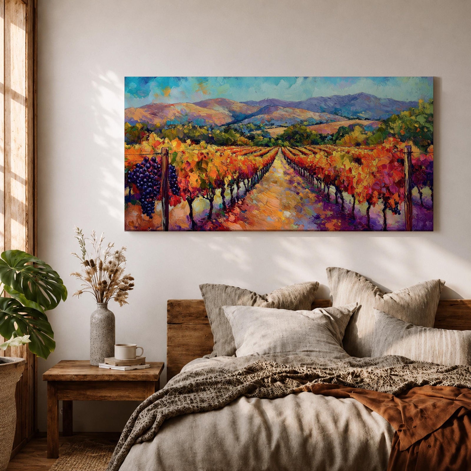 A panoramic vineyard landscape painting showing long rows of grapevines covered in red and golden autumn leaves stretching toward distant mountains beneath a bright sky. Purple grape clusters hang beside the vines while a central path leads through the field, capturing a colorful wine country valley with bold impressionist brushstrokes.