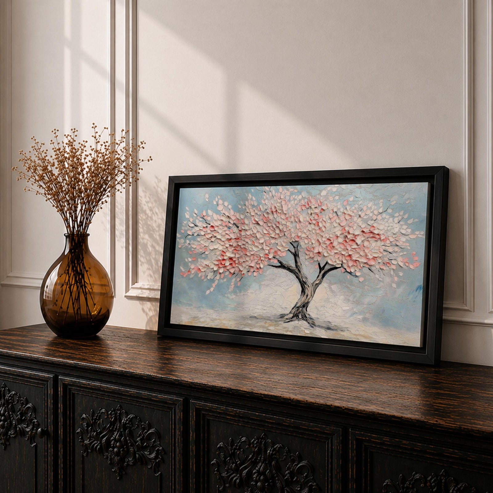 Panoramic textured painting of a cherry blossom tree with a twisting dark trunk and a wide canopy of soft pink blossoms spreading across a pale blue sky. Thick palette knife strokes create layered petals and raised textures, forming a calm spring landscape with delicate floral clusters and gentle pastel tones.