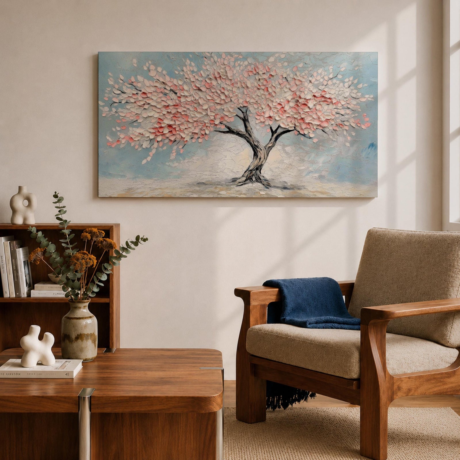 Panoramic textured painting of a cherry blossom tree with a twisting dark trunk and a wide canopy of soft pink blossoms spreading across a pale blue sky. Thick palette knife strokes create layered petals and raised textures, forming a calm spring landscape with delicate floral clusters and gentle pastel tones.