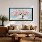 Panoramic textured painting of a cherry blossom tree with a twisting dark trunk and a wide canopy of soft pink blossoms spreading across a pale blue sky. Thick palette knife strokes create layered petals and raised textures, forming a calm spring landscape with delicate floral clusters and gentle pastel tones.
