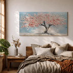 Panoramic textured painting of a cherry blossom tree with a twisting dark trunk and a wide canopy of soft pink blossoms spreading across a pale blue sky. Thick palette knife strokes create layered petals and raised textures, forming a calm spring landscape with delicate floral clusters and gentle pastel tones.